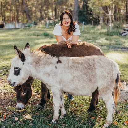 A guest with the donkeys at Little Donkey Estate